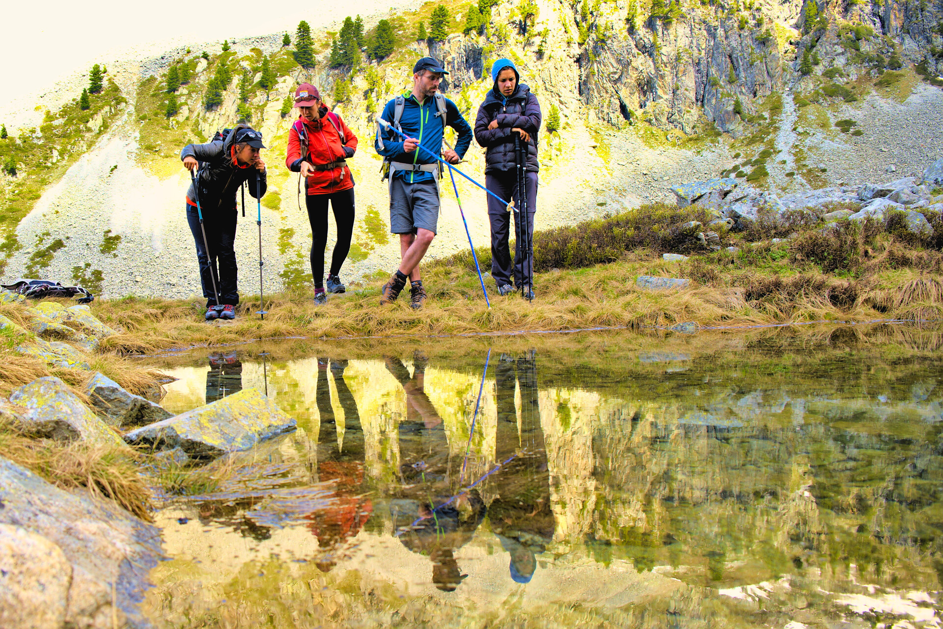 Walkers taking a break beside a mountain lake